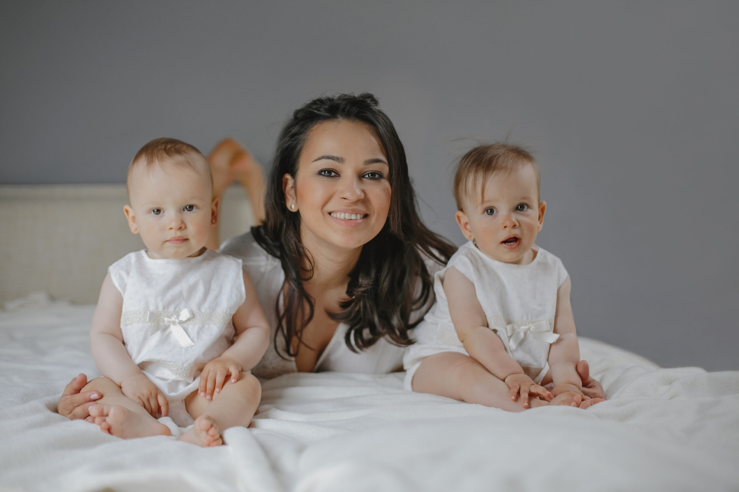 smiling parent holding twin babies the joy of dual surrogacy